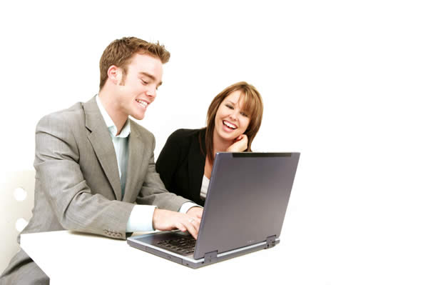 Adults contributing at laptop